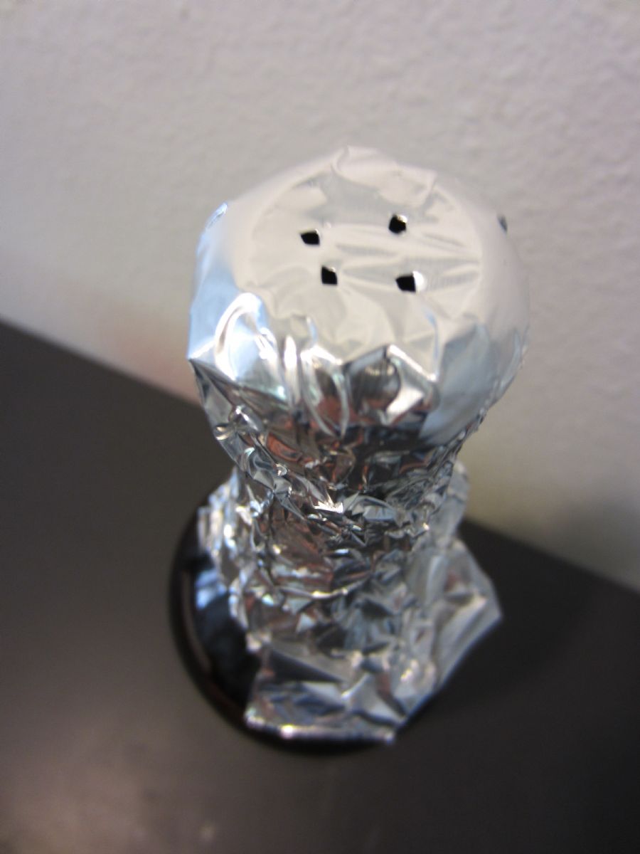 Placing Sanitized Aluminum Foil on Mouth of Bottle